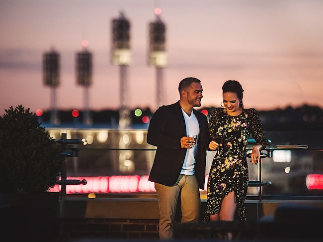 couple dining with skyline in background